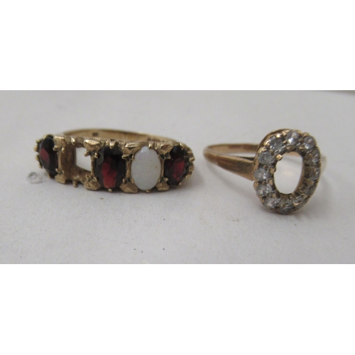 259 - Two 9ct gold rings, one set with garnets, the other white stones