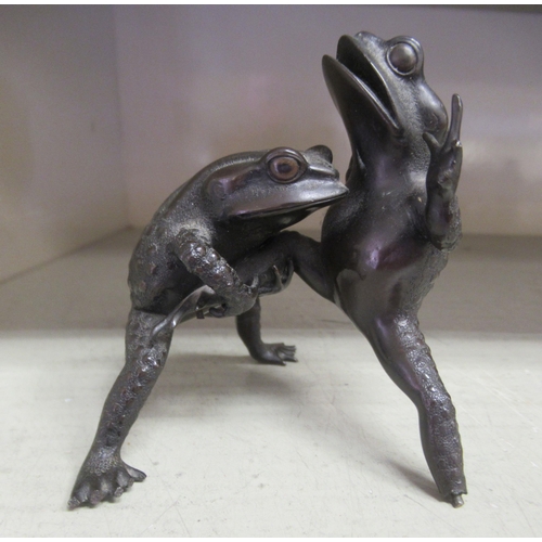 26 - 20thC Oriental artefacts, viz. a pair of cast bronze fighting toads  3.5