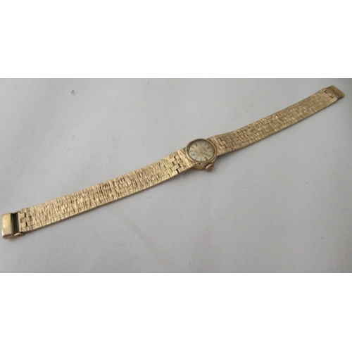 267 - A lady's Rotary 9ct gold case and strap wristwatch, faced by a baton dial