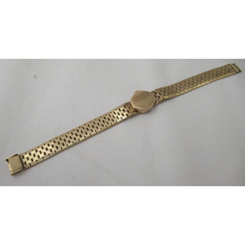 267 - A lady's Rotary 9ct gold case and strap wristwatch, faced by a baton dial