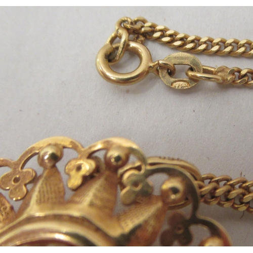 268 - An 18ct gold curb link neckchain with a yellow metal pendant, set with a shell carved cameo