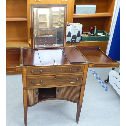 28 - A George III mahogany and satinwood string inlaid fold-out valet/dressing table, in the manner of Gi... 