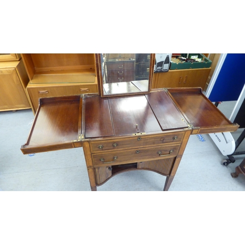 28 - A George III mahogany and satinwood string inlaid fold-out valet/dressing table, in the manner of Gi... 