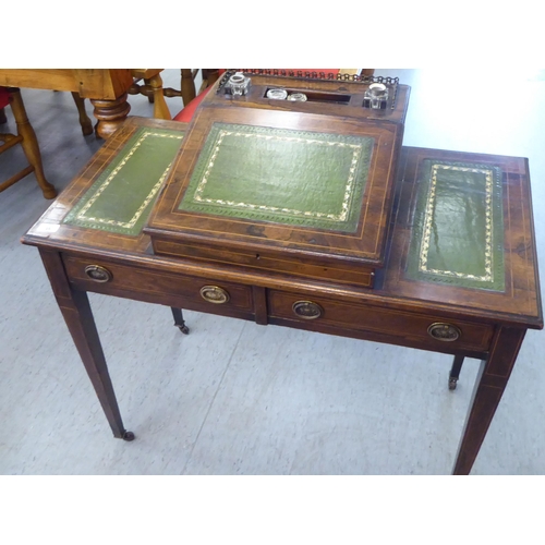 35 - A late Victorian satinwood inlaid rosewood governess's desk, having a raised central inkstand and an... 