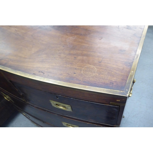 38 - An early 19thC and later mahogany two part bow front campaign inspired dressing chest with brass rei... 