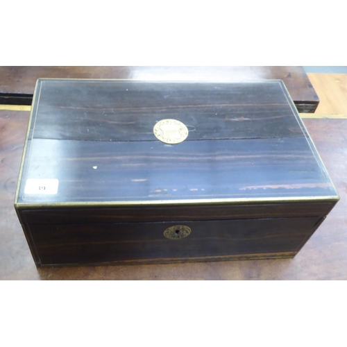 39 - A 19thC brass inlaid Macassar ebony writing box, the angled hinged lid enclosing a fitted interior&n... 