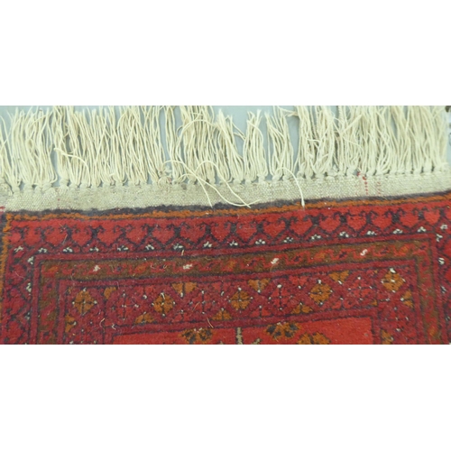 44 - Rugs: to include a Bokhara with a pole medallion, on a red ground  70