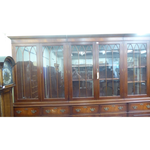 57 - A 20thC reproduction of a Georgian mahogany library bookcase, the upper section with three pairs of ... 