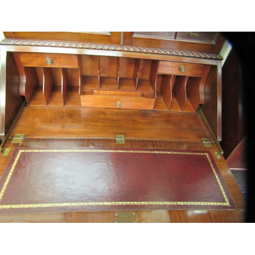 58 - A 1930s Georgian style mahogany bureau cabinet bookcase, the upper section with a pair of glazed doo... 