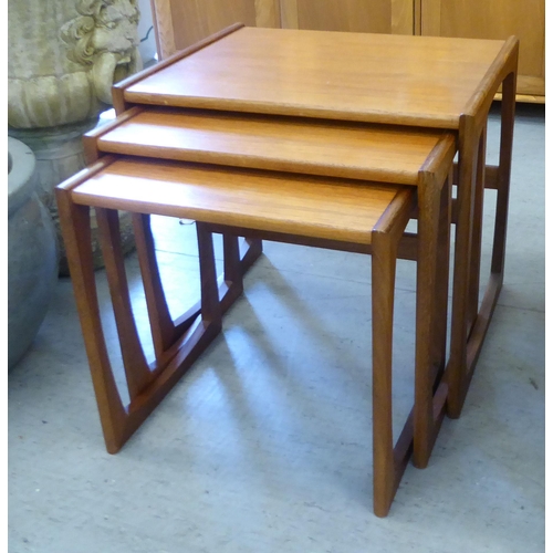 67 - A nesting set of three G-Plan Astro teak occasional tables, raised on open underframes  largest 19