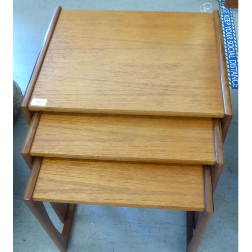 67 - A nesting set of three G-Plan Astro teak occasional tables, raised on open underframes  largest 19