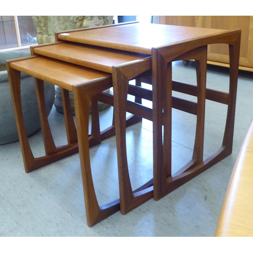 67 - A nesting set of three G-Plan Astro teak occasional tables, raised on open underframes  largest 19