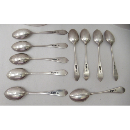 73 - A set of ten silver coffee spoons with engraved stems; and a silver sweet basket of oval form, with ... 