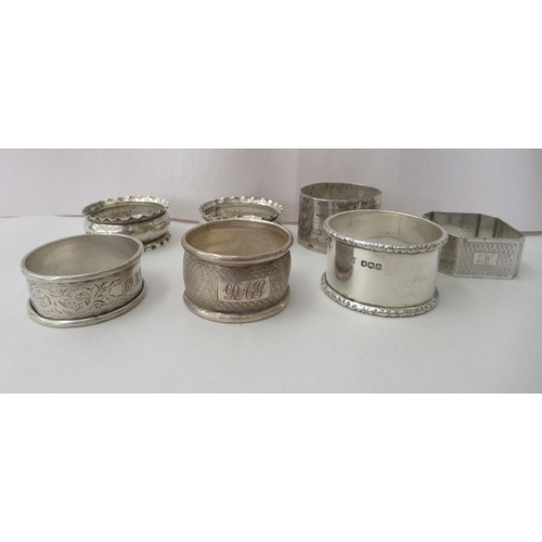 88 - Seven variously decorated silver napkin rings: to include a pair with crimped rims  mixed marks... 