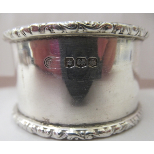 88 - Seven variously decorated silver napkin rings: to include a pair with crimped rims  mixed marks... 