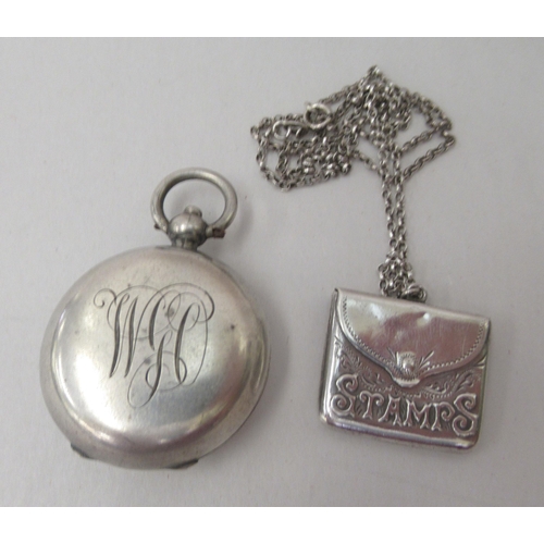 95 - Silver, viz. an engraved chatelaine clip and spectacles case; a postage stamp pendant, on a fine nec... 