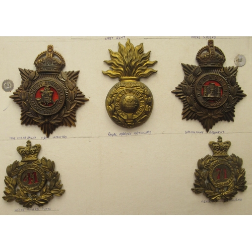 100 - Nine military helmet and shako plates, some copies: to include Royal Marine Artillery and Duke of Co... 