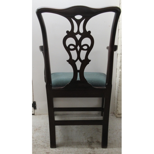 106 - An early 19thC Chippendale inspired mahogany framed elbow chair with a pierced splat and shaped, lev... 