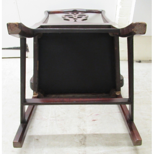 106 - An early 19thC Chippendale inspired mahogany framed elbow chair with a pierced splat and shaped, lev... 