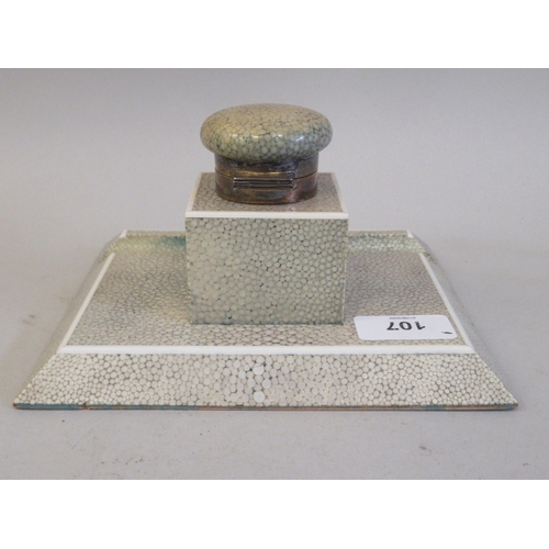 107 - A two-part shagreen covered deskstand, the chamfered platform incorporating a pen channel, surmounte... 