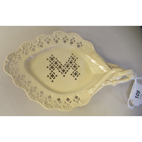 109 - A late 18thC creamware leaf dish with uniformly pierced ornament and an entwined handle  8.5