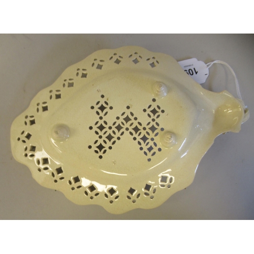 109 - A late 18thC creamware leaf dish with uniformly pierced ornament and an entwined handle  8.5