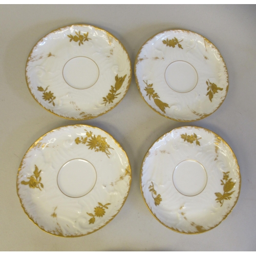 112 - A late 19thC Limoges ivory glazed and gilded porcelain cabaret set, decorated with floral sprigs&nbs... 