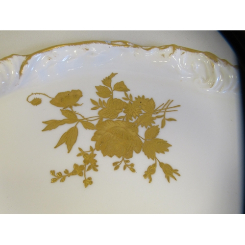 112 - A late 19thC Limoges ivory glazed and gilded porcelain cabaret set, decorated with floral sprigs&nbs... 