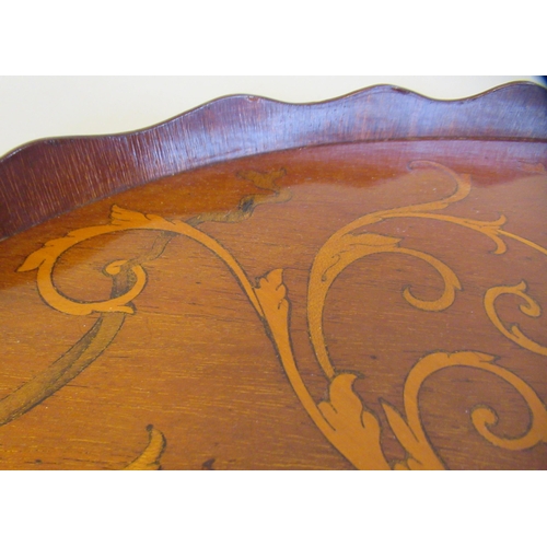 117 - A late 19thC galleried kidney shape serving tray with marquetry ornament and opposing brass handset ... 