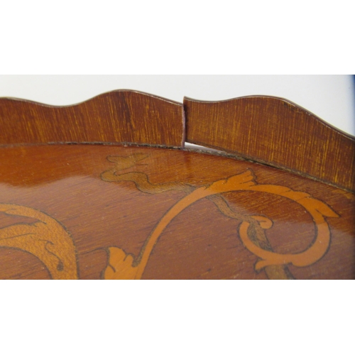 117 - A late 19thC galleried kidney shape serving tray with marquetry ornament and opposing brass handset ... 