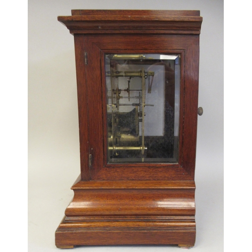 118 - A 19thC mahogany cased bracket timepiece with bevelled glass panels and visible escapement, on an og... 