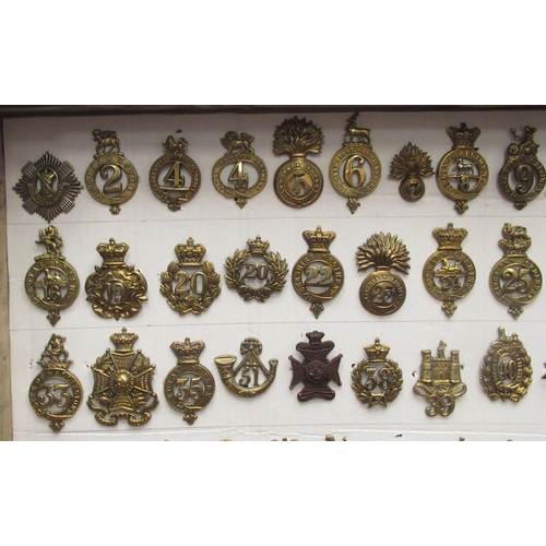 135 - Approx. seventy-five military cap badges and other insignia, some copies: to include Royal Irish, Th... 