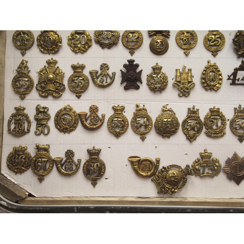 135 - Approx. seventy-five military cap badges and other insignia, some copies: to include Royal Irish, Th... 