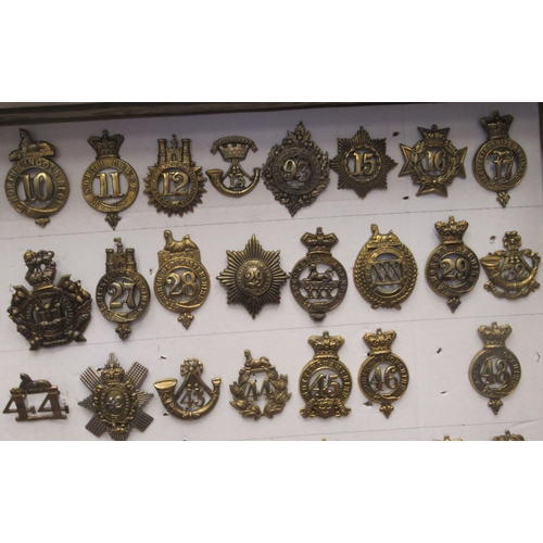 135 - Approx. seventy-five military cap badges and other insignia, some copies: to include Royal Irish, Th... 