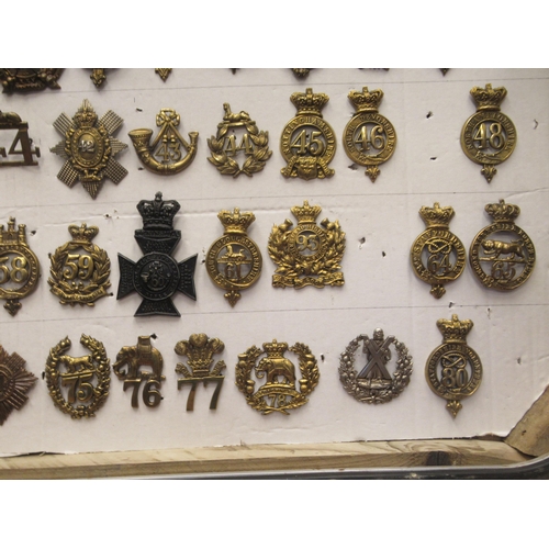 135 - Approx. seventy-five military cap badges and other insignia, some copies: to include Royal Irish, Th... 