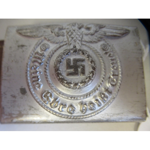 144 - A German SS military silvered belt buckle, on a section with an impressed 1940 mark   (Please Note: ... 