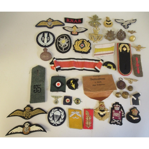 148 - Miscellaneous post 1915 militaria: to include RAF and RFC uniform badges, lanyards and assorted bank... 