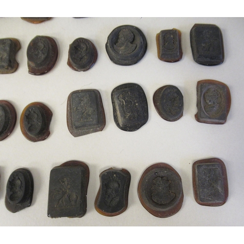 168 - A miscellaneous collection of moulded glass intaglios and seals