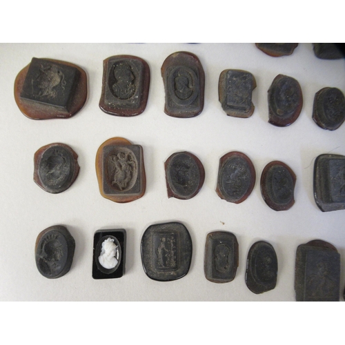 168 - A miscellaneous collection of moulded glass intaglios and seals