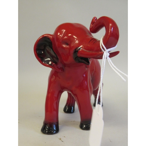 184 - A Royal Doulton flambe glazed model, a trumpeting elephant  5.5