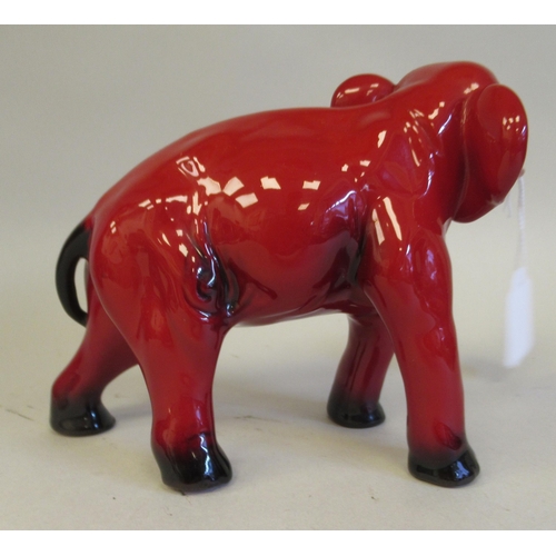 184 - A Royal Doulton flambe glazed model, a trumpeting elephant  5.5