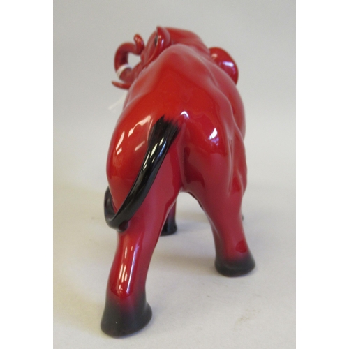 184 - A Royal Doulton flambe glazed model, a trumpeting elephant  5.5