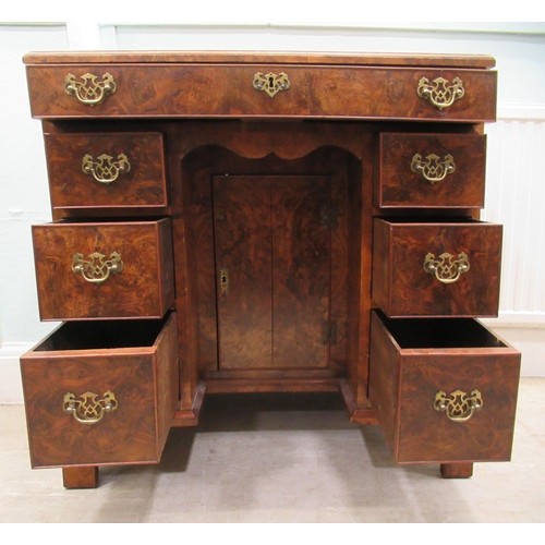 186 - A 19thC figured veneer walnut kneehole desk, over a shallow frieze drawer, flanked by six short draw... 