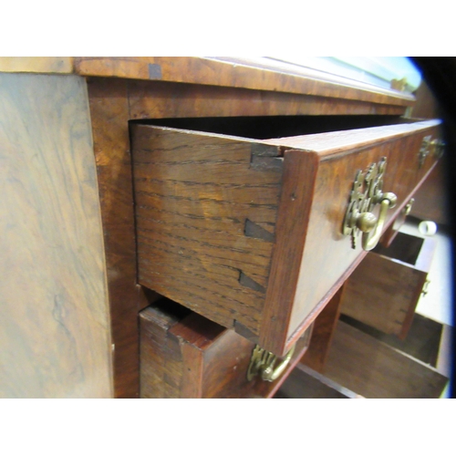 186 - A 19thC figured veneer walnut kneehole desk, over a shallow frieze drawer, flanked by six short draw... 