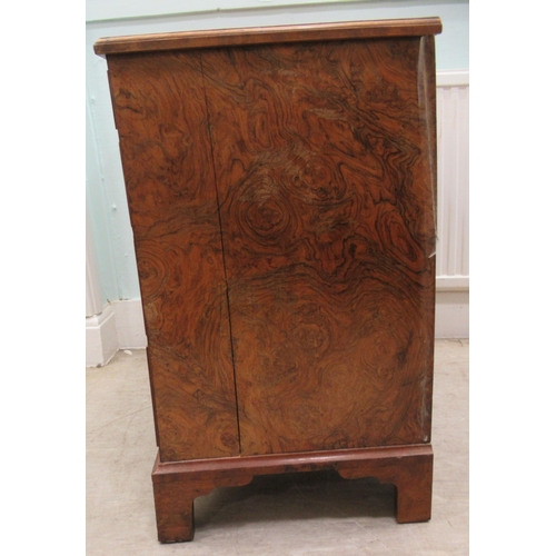 186 - A 19thC figured veneer walnut kneehole desk, over a shallow frieze drawer, flanked by six short draw... 