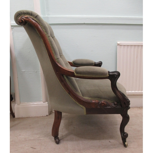 187 - An early Victorian carved showwood framed rosewood library chair with a scrolled back and open arms,... 