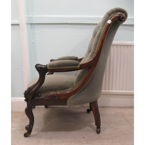 187 - An early Victorian carved showwood framed rosewood library chair with a scrolled back and open arms,... 