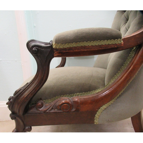 187 - An early Victorian carved showwood framed rosewood library chair with a scrolled back and open arms,... 