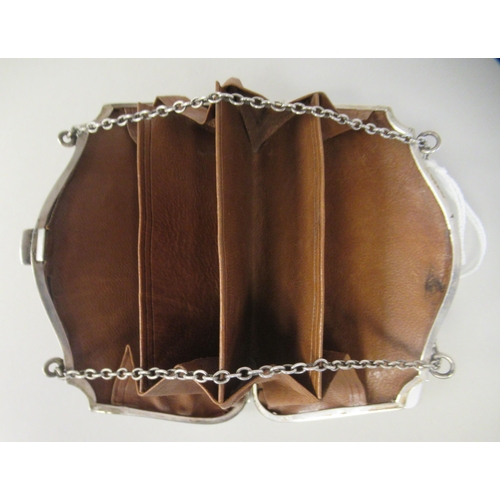 198 - An Edwardian silver purse with engine turned decoration and a chain handle, on a button clasp, enclo... 