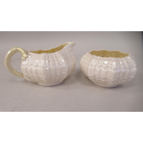 214 - A Belleek Third Period cream coloured lustre glazed, moulded porcelain teaset, comprising six cups, ... 